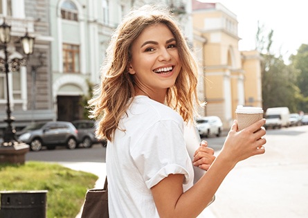 Woman smiling while walking outside