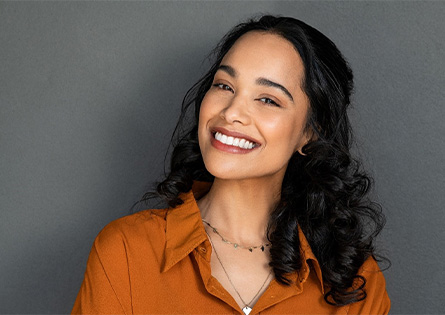Smiling woman in an orange blouse
