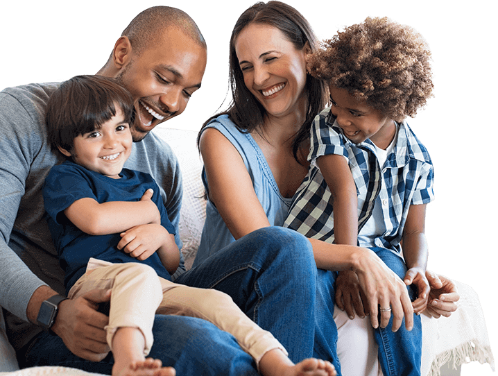 Two young children sitting in their parents laps