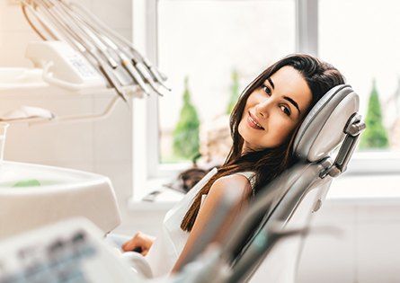 Woman in dental chair smiling during dental checkup