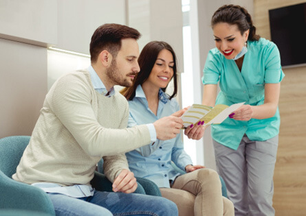 a couple discussing how to pay for their tooth extractions