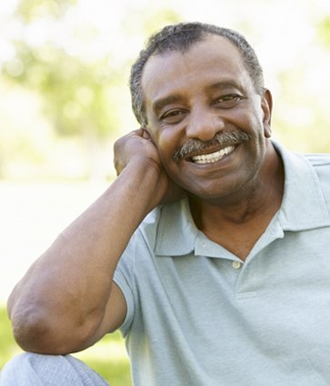 An older man with smiling after affordable care from the delta dental dentist