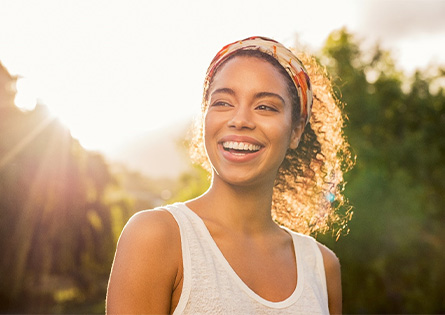 woman smiling after practicing dental implant care in North Dallas