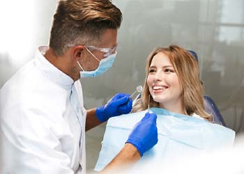 woman talking to her dentist at a routine checkup