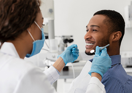 a patient smiling before tooth extractions in North Dallas