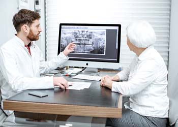 dentist showing a patient their X-rays