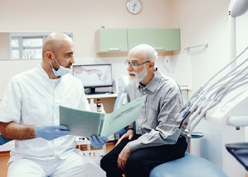 Implant dentist in North Dallas explaining treatment to a patient