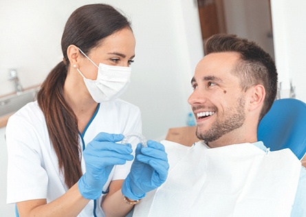 Dentist and patient smiling during Invisalign appointment
