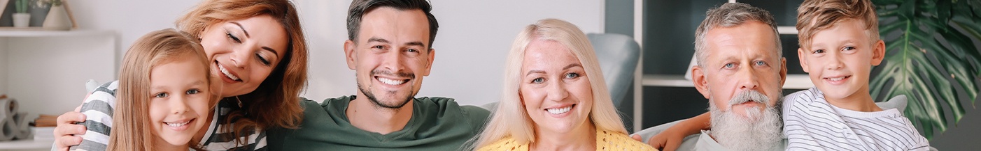 family smiling after visiting their dentist near Preston Road