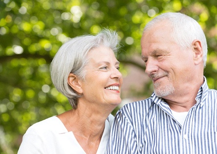 An older couple with MetLife dental insurance smiling at each other