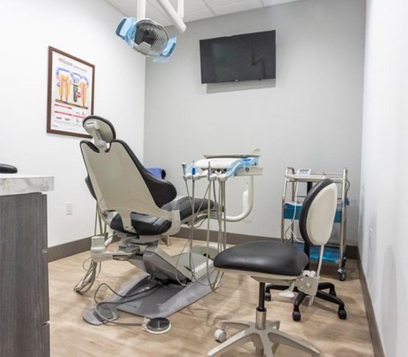Dental exam room with a television mounted on the wall
