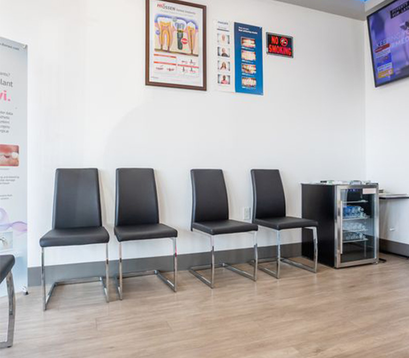 Row of black chairs in waiting area