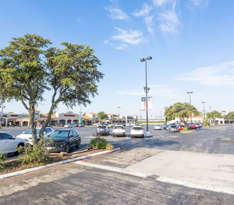 Partially empty parking lot outside of Coco Dental of North Dallas