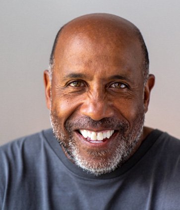 Middle aged man smiling after full mouth reconstruction in North Dallas