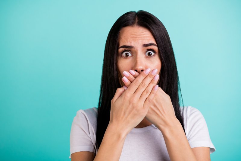 Woman covering her mouth in shock