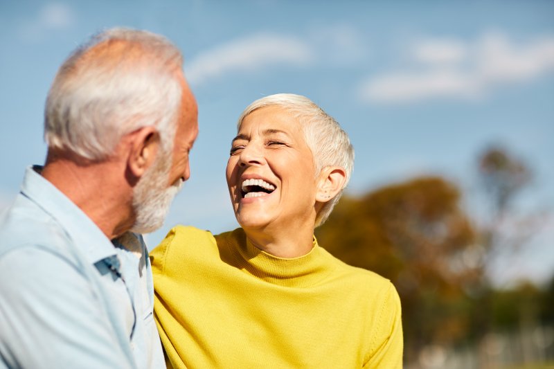 couple laughing with dental implants in Dallas