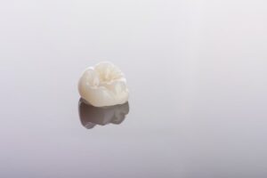 closeup of a dental crown on a smooth countertop