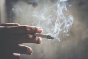 Hand holding cigarette.